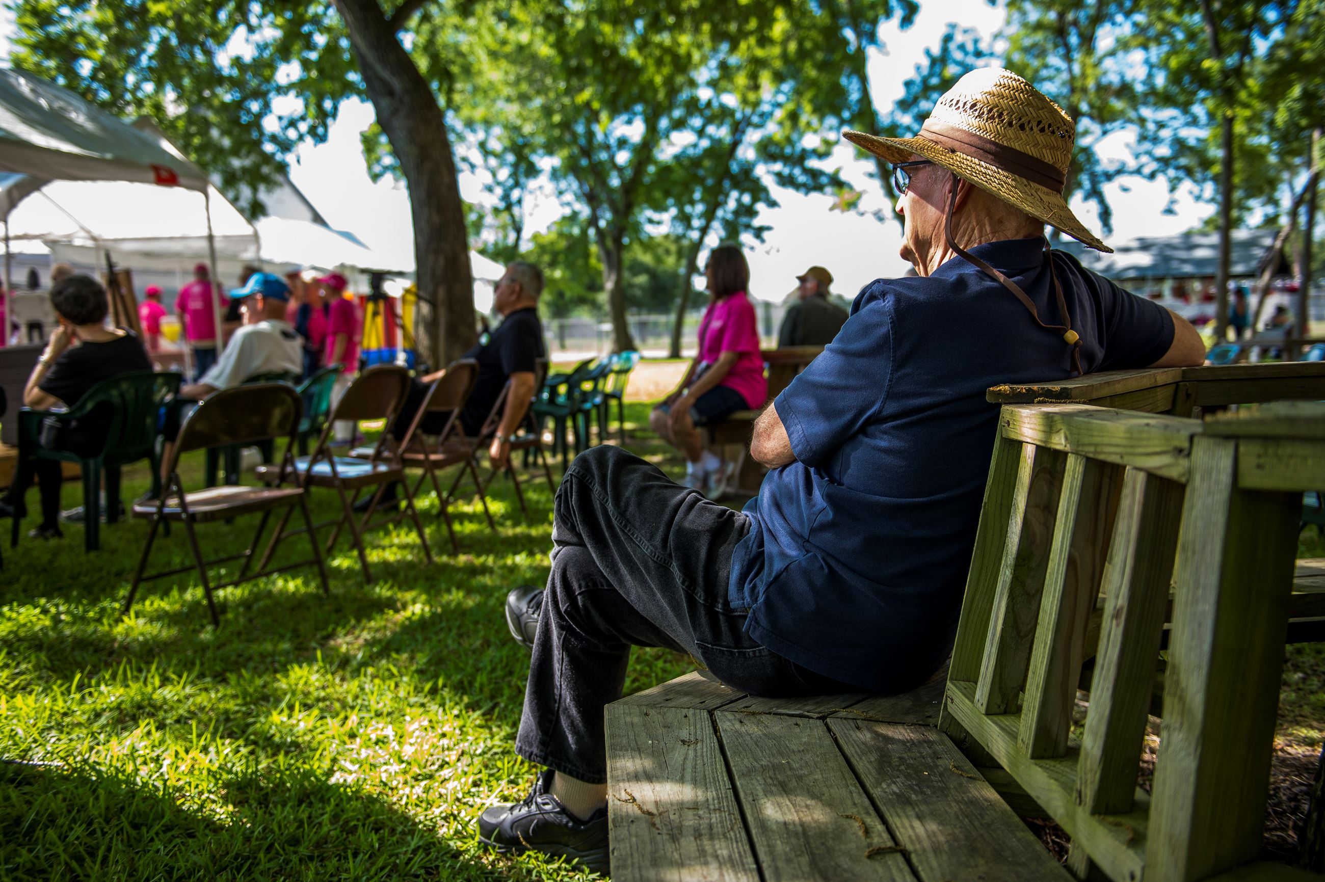 Man sitting on a park bench at Heritage Park