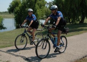 Two officers ride bikes
